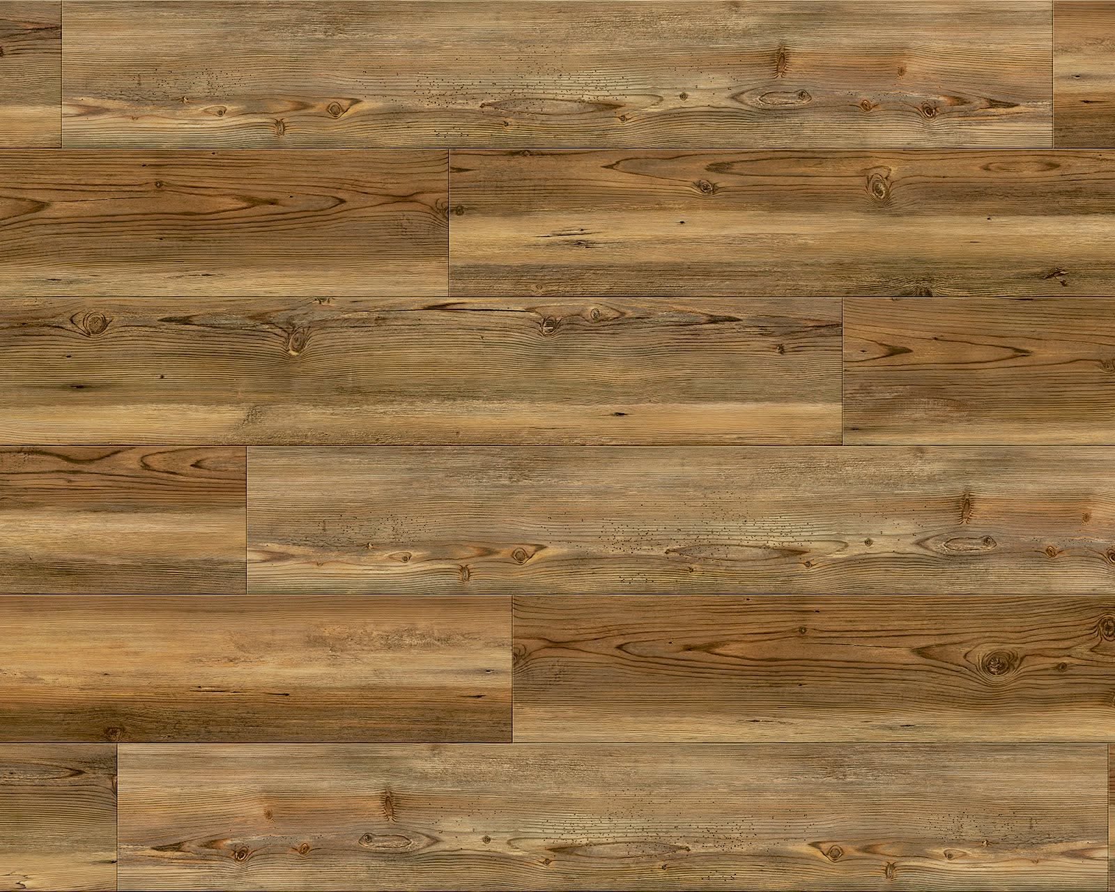 Close-up of a living space showing light wood plank flooring, a grey armchair, and a side table.